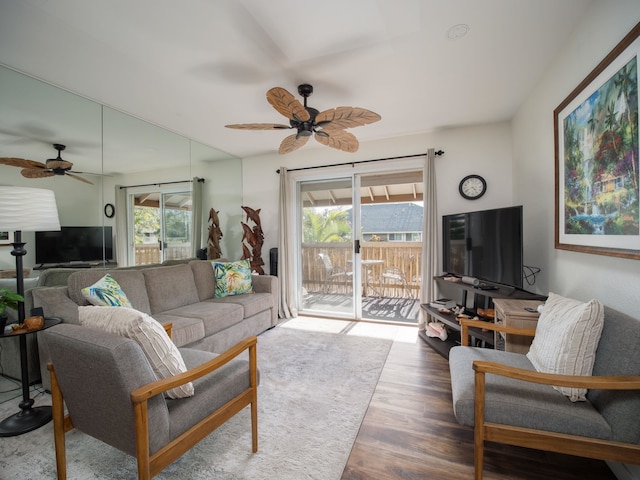 living room with wood-type flooring and ceiling fan