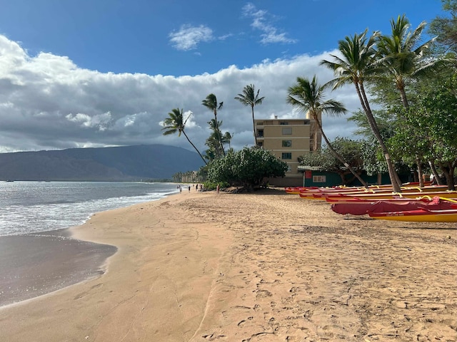 exterior space with a beach view and a mountain view