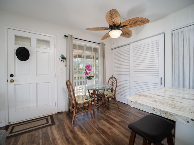 dining area with ceiling fan and dark wood-type flooring