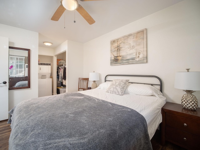 bedroom with a spacious closet, a closet, ceiling fan, and dark hardwood / wood-style floors