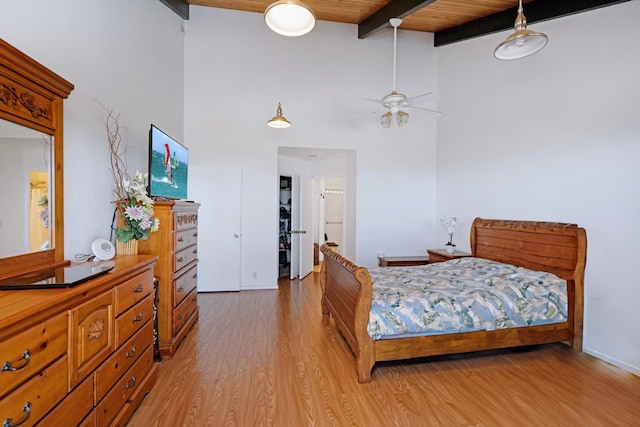 bedroom featuring wood ceiling, ceiling fan, high vaulted ceiling, beamed ceiling, and light hardwood / wood-style floors