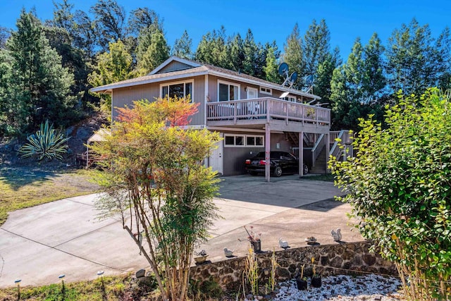 view of front of property featuring a garage and a wooden deck