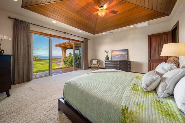 carpeted bedroom featuring wooden ceiling, ceiling fan, a tray ceiling, and access to outside