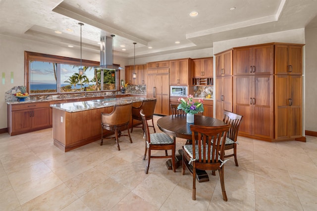 dining space featuring a raised ceiling