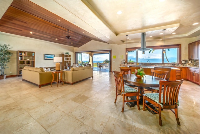 dining room featuring wood ceiling, ceiling fan, and a raised ceiling