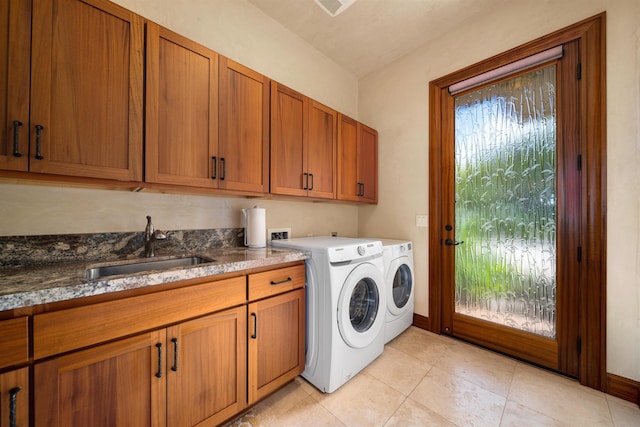 washroom with cabinets, washing machine and dryer, sink, and light tile patterned floors