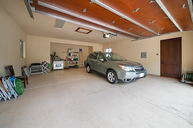 garage with electric panel and a garage door opener