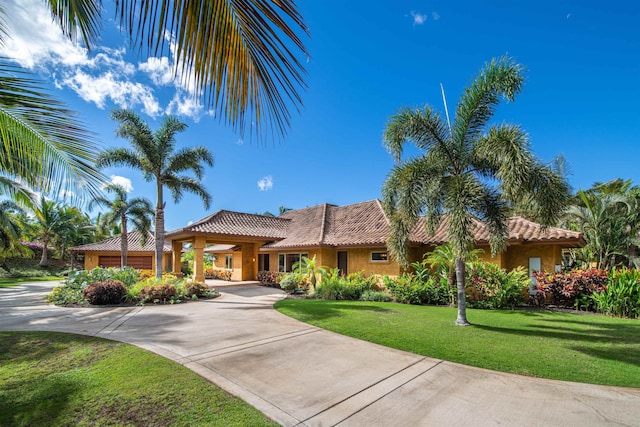 mediterranean / spanish house with a front yard