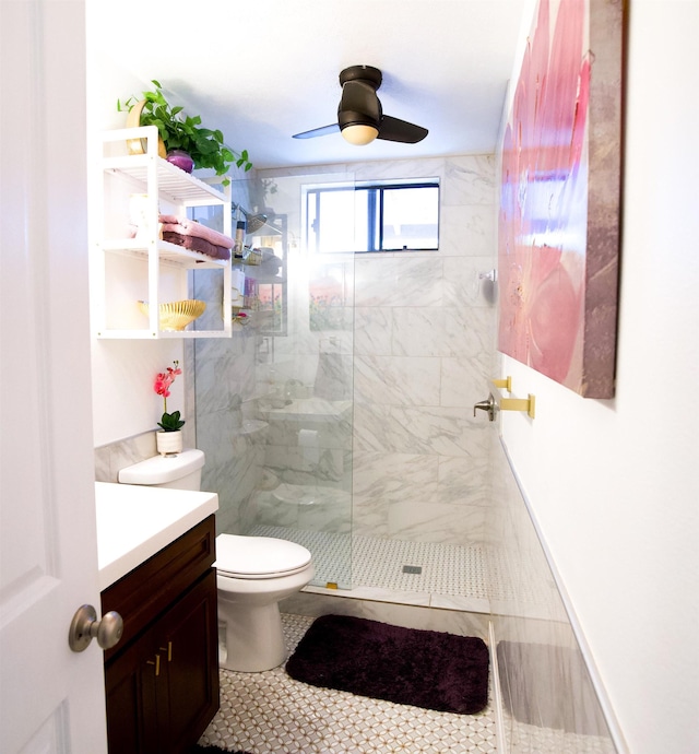 bathroom with toilet, a ceiling fan, vanity, tile patterned flooring, and walk in shower