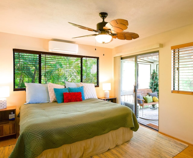 bedroom featuring access to exterior, wood finished floors, a wall mounted air conditioner, and multiple windows