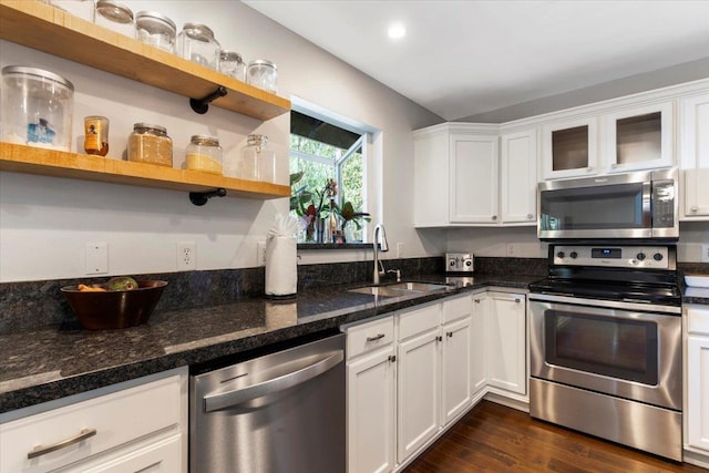 kitchen featuring a sink, open shelves, stainless steel appliances, white cabinets, and dark wood-type flooring