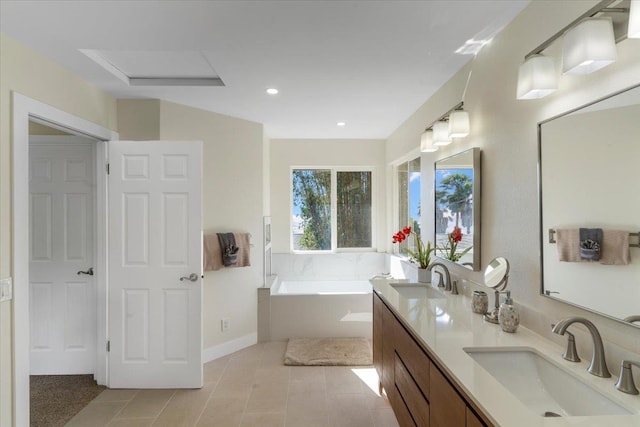 bathroom featuring double vanity, a bath, tile patterned flooring, and a sink