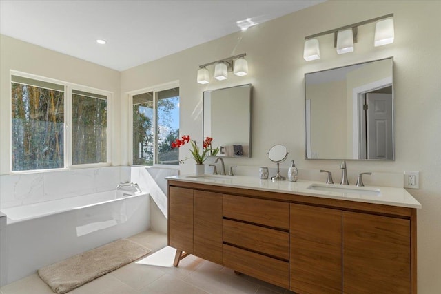 bathroom featuring double vanity, a sink, tile patterned flooring, and a bath