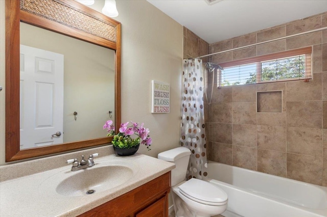 full bath with toilet, vanity, and shower / bath combo