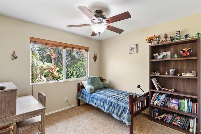 carpeted bedroom featuring baseboards and ceiling fan