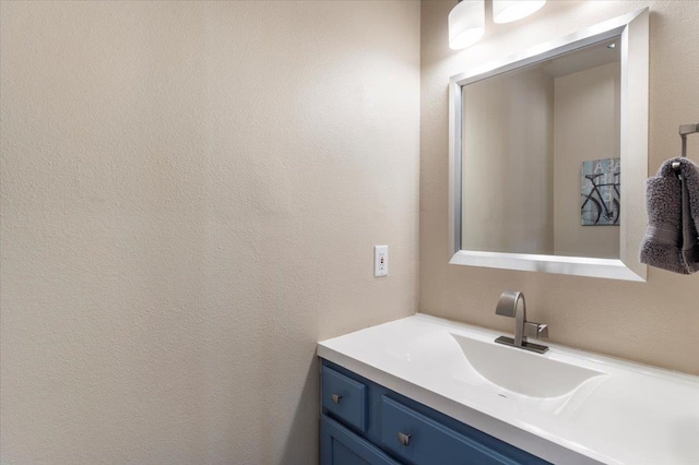 bathroom featuring vanity and a textured wall