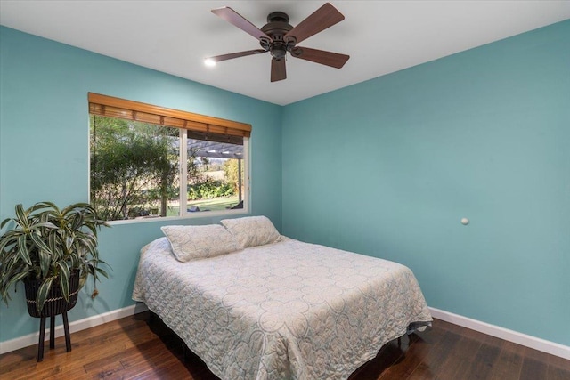 bedroom featuring hardwood / wood-style flooring, baseboards, and ceiling fan