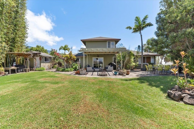 rear view of property featuring a fire pit, a pergola, a yard, and a patio