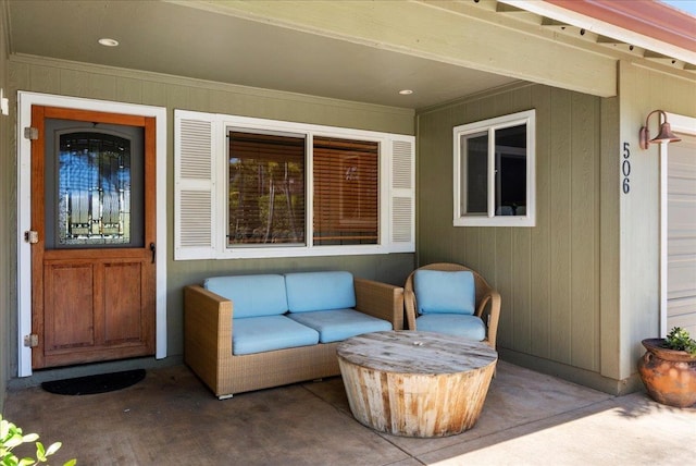 property entrance featuring an outdoor living space and a patio
