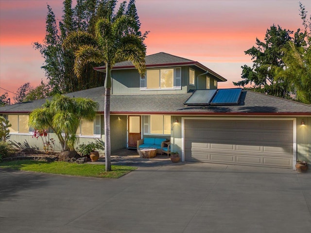 view of front of house featuring stucco siding, a shingled roof, concrete driveway, and an attached garage