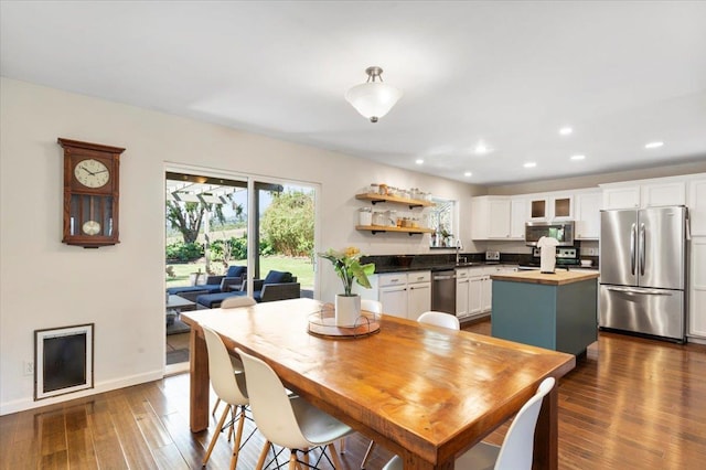 dining space featuring baseboards, recessed lighting, and dark wood-style flooring