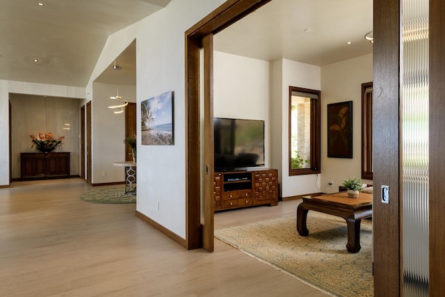 corridor with light hardwood / wood-style floors