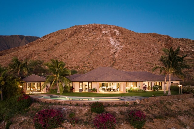 exterior space with a mountain view and a patio