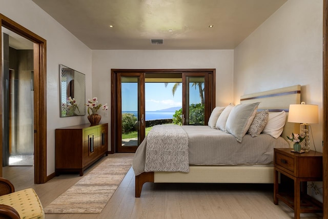 bedroom with light hardwood / wood-style floors and access to outside