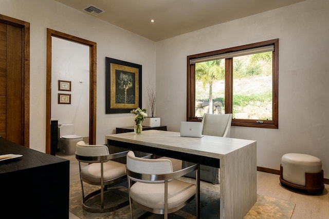 home office with light hardwood / wood-style floors