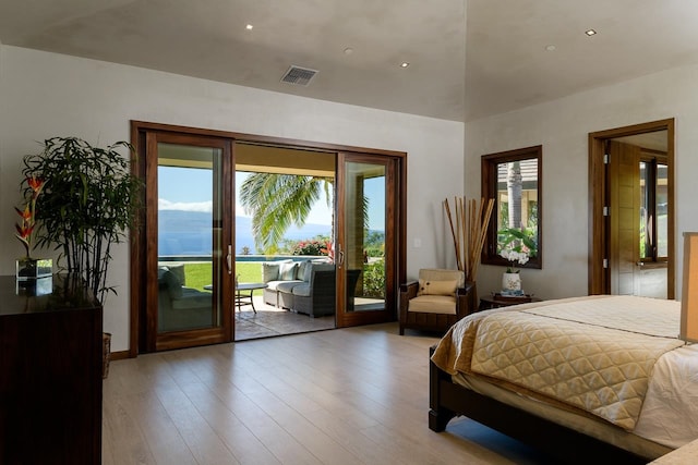 bedroom with access to outside and light wood-type flooring