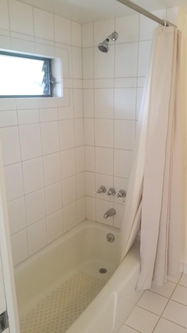 bathroom with tile patterned flooring and shower / tub combo