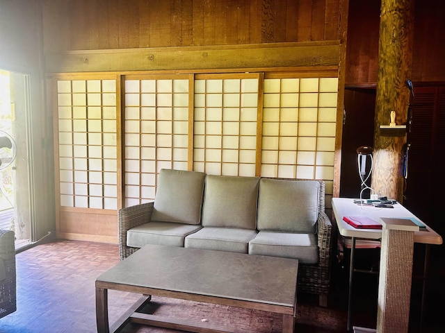 living room featuring wood walls