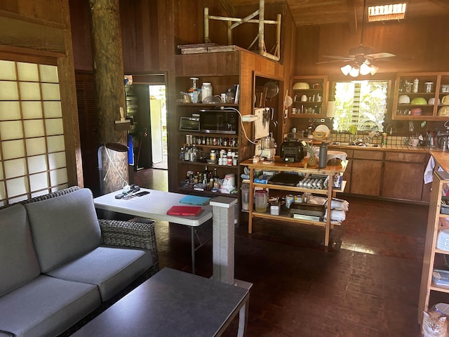 dining room featuring wooden walls and ceiling fan