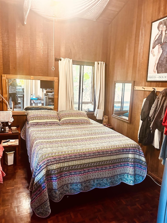 bedroom with access to exterior, wooden walls, and parquet floors