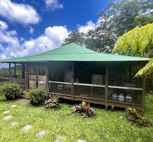 rear view of property with a yard