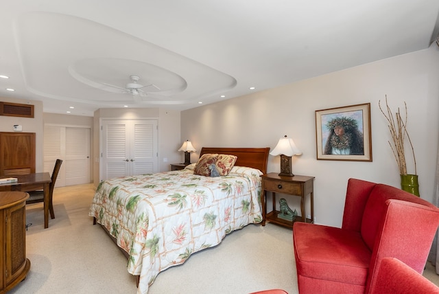 bedroom featuring a tray ceiling, ceiling fan, and carpet