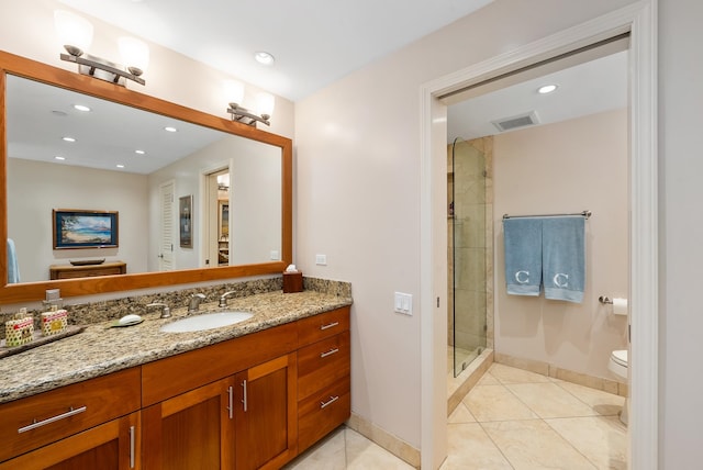 bathroom with tile floors, toilet, oversized vanity, and a shower with shower door