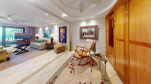 sitting room featuring ceiling fan and light tile floors