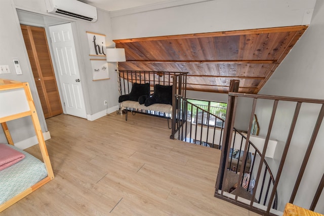 811 S Kihei Rd Unit 2H, Kihei, HI 96753 - hall featuring an AC wall unit, wooden ceiling, wood finished floors, an upstairs landing, and baseboards