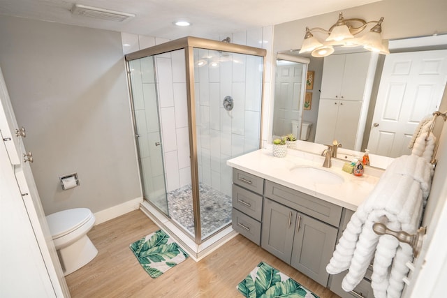 811 S Kihei Rd Unit 2H, Kihei, HI 96753 - bathroom with toilet, vanity, a shower stall, wood finished floors, and recessed lighting