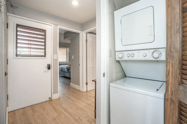 811 S Kihei Rd Unit 2H, Kihei, HI 96753 - laundry room featuring stacked washer and clothes dryer, light wood-style floors, baseboards, and recessed lighting