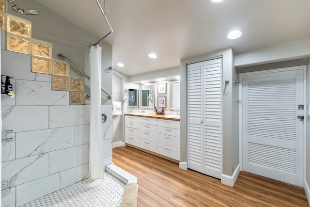 bathroom with vanity, wood-type flooring, and walk in shower