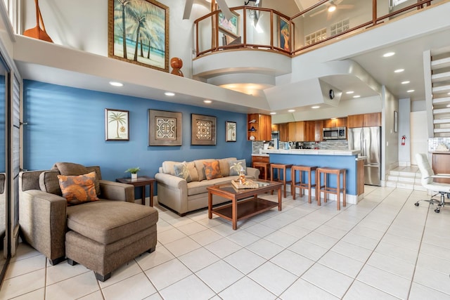 tiled living room featuring a towering ceiling