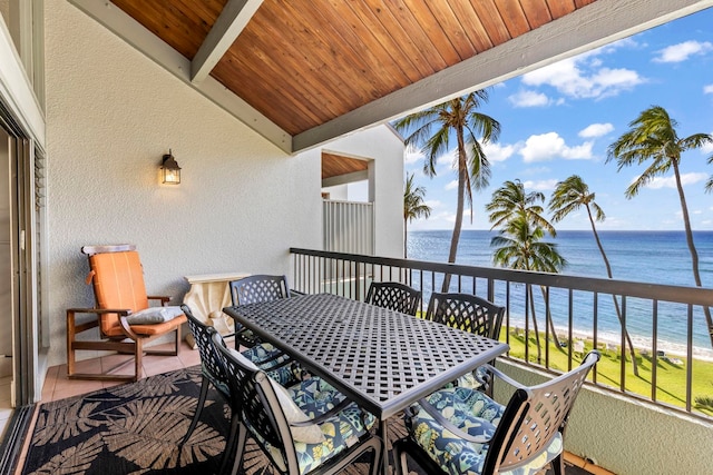 balcony with a water view and a beach view