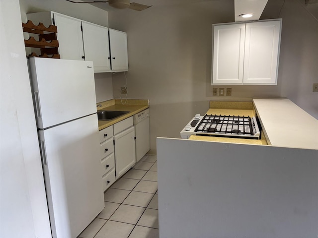1000 Kam V Hwy Unit 320B, Kaunakakai, HI 96748 - kitchen with white appliances, light tile patterned floors, white cabinets, light countertops, and ceiling fan