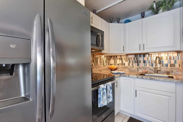 4327 Lower Honoapiilani Rd Unit 207B, Lahaina, HI 96761 - kitchen with stainless steel appliances, white cabinetry, tasteful backsplash, and sink