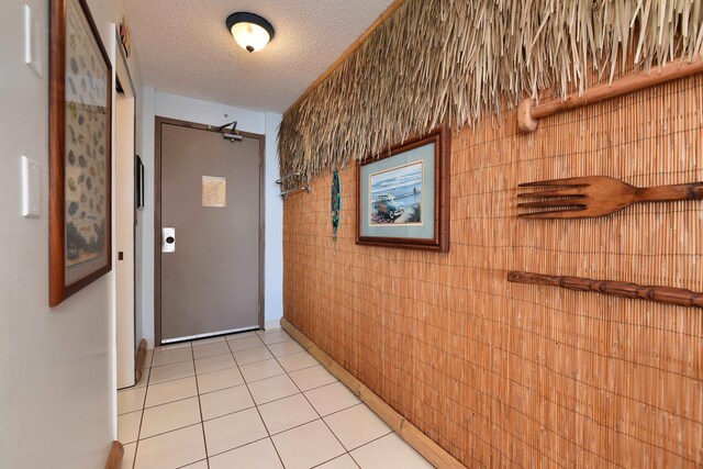 4327 Lower Honoapiilani Rd Unit 207B, Lahaina, HI 96761 - hallway with light tile patterned floors and a textured ceiling