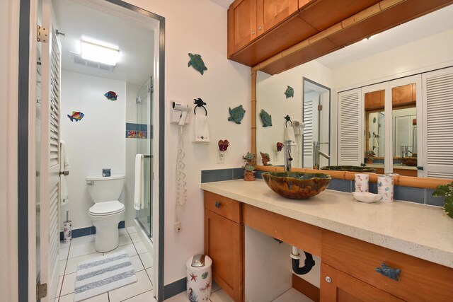 4327 Lower Honoapiilani Rd Unit 207B, Lahaina, HI 96761 - bathroom featuring tile patterned flooring, vanity, toilet, and a shower with door