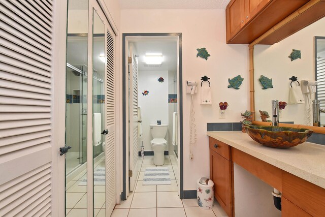 4327 Lower Honoapiilani Rd Unit 207B, Lahaina, HI 96761 - bathroom featuring tile patterned flooring, vanity, toilet, and an enclosed shower