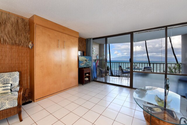 4327 Lower Honoapiilani Rd Unit 207B, Lahaina, HI 96761 - tiled living room with floor to ceiling windows and a textured ceiling